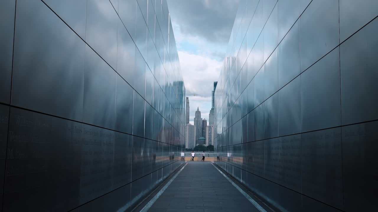 Jersey City, USA, 1 July 2025: Walk inside the Empty Sky memorial in New Jersey, USA. Towers of Manhattan and cloudy sky at backdrop