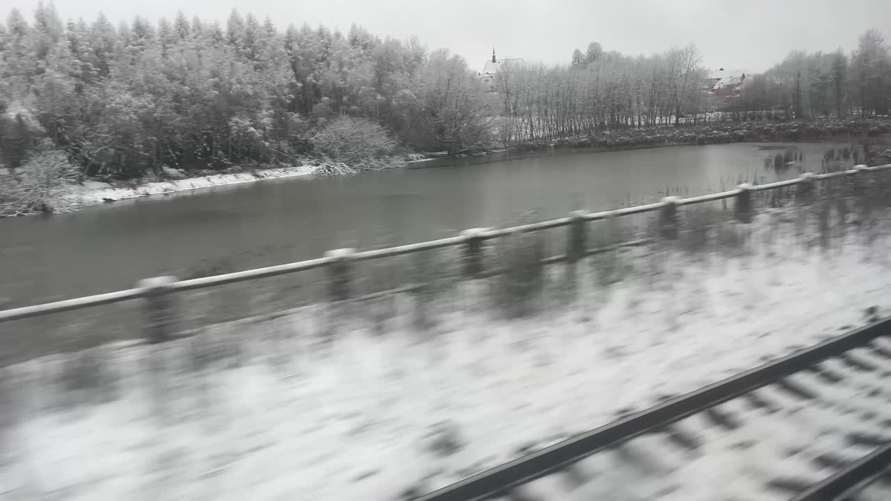 Winter landscape with snow-covered trees and railroad tracks