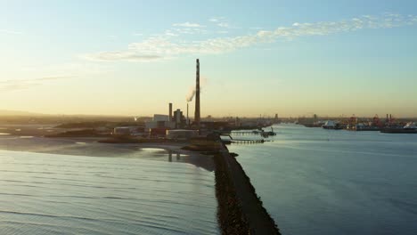 aerial of dublin bay power plan in ireland at sunset, dolly in