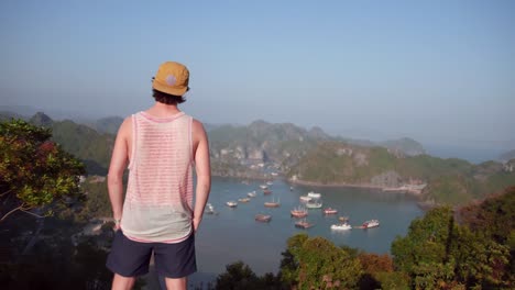 back view of a man looking at the view in catba island in vietnam - beautiful tourist destination - aerial shot