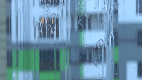 streams of water and raindrops on the window glass in heavy rain, background