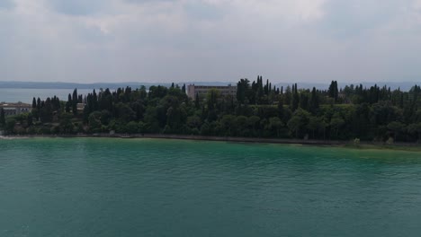 view of the castle and peninsula transitioning into lush lakeside greenery
