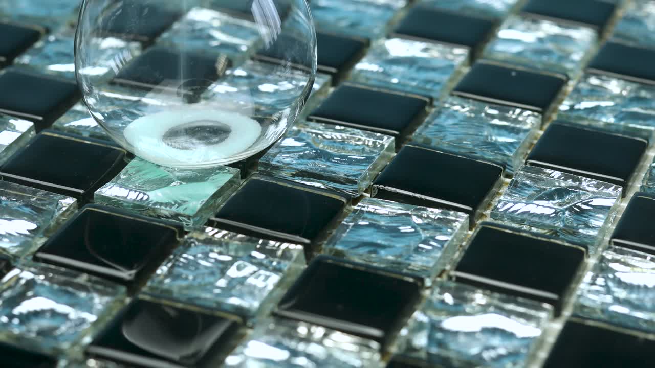 The black-and-white mosaic turns in a circle.