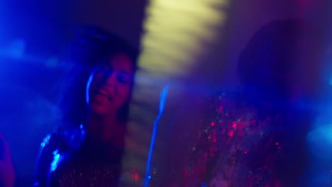 Close-Up-Of-Two-Women-In-Nightclub-Bar-Or-Disco-Dancing-With-Sparkling-Lights-4