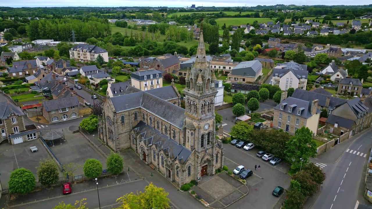 Panoramic drone movement around the ornate and ancient Saint-Sauveur Church of Plancoet, Côtes-d'Armor, Brittany, France.