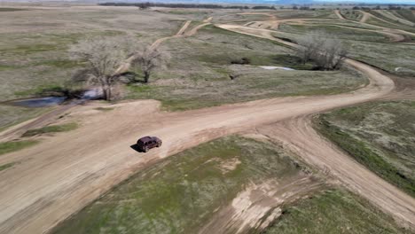 Following-a-four-wheel-drive-car-with-a-drone-on-a-dirt-road