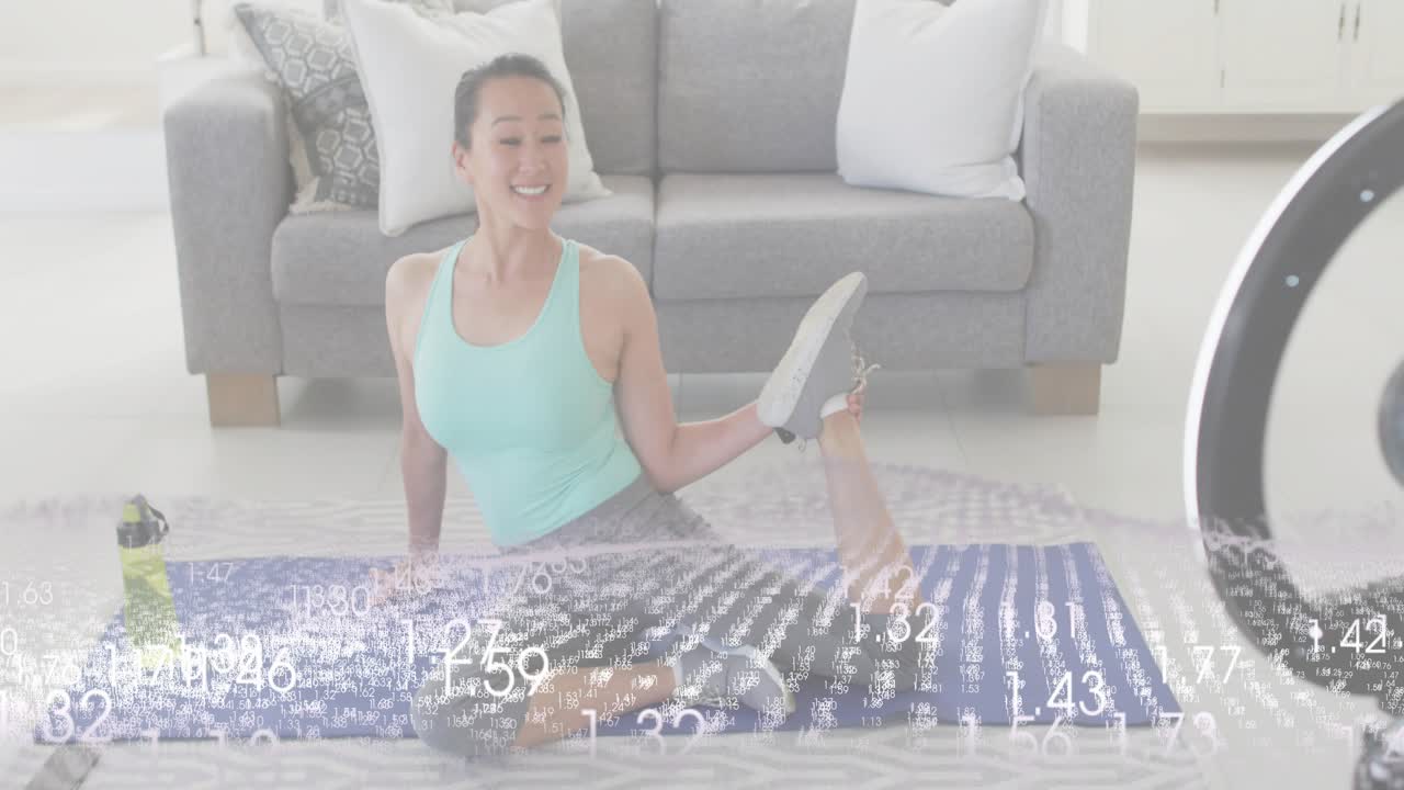 Fitness trainer unfolding yoga mat stretching for warmup as timer graphics popping near ring light