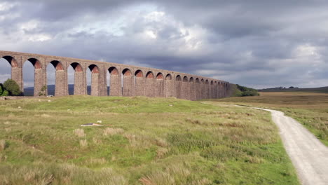 rising aerial shot revealing ribblehead viaduct in the yorkshire dales national park