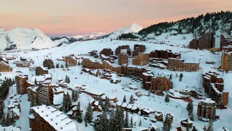 aerial: beautiful avoriaz ski resort in french alps, winter panoramic at sunset