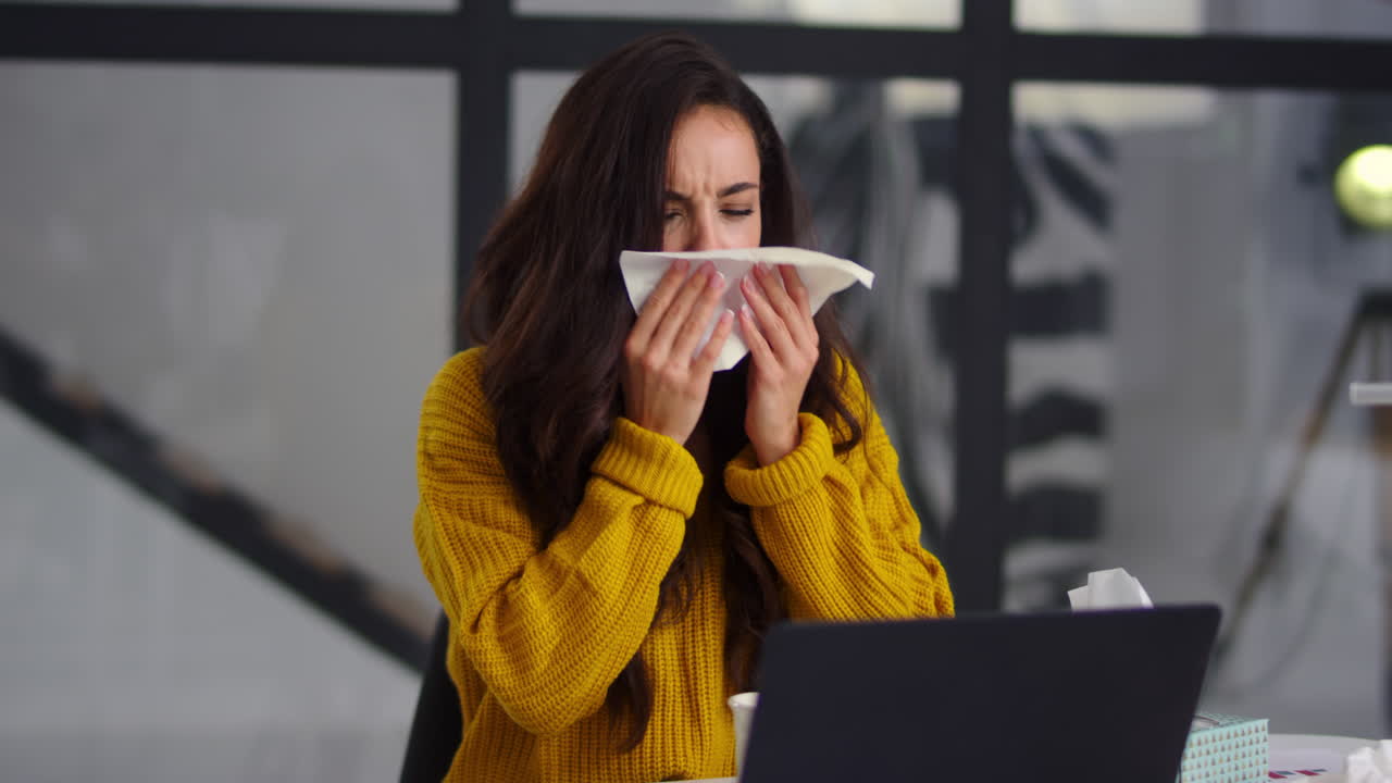 Sick businesswoman getting flu in office