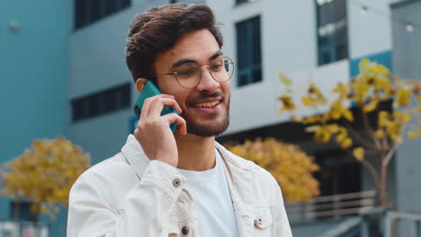 happy surprised indian man involved in pleasant conversation phone call good news enjoying talking