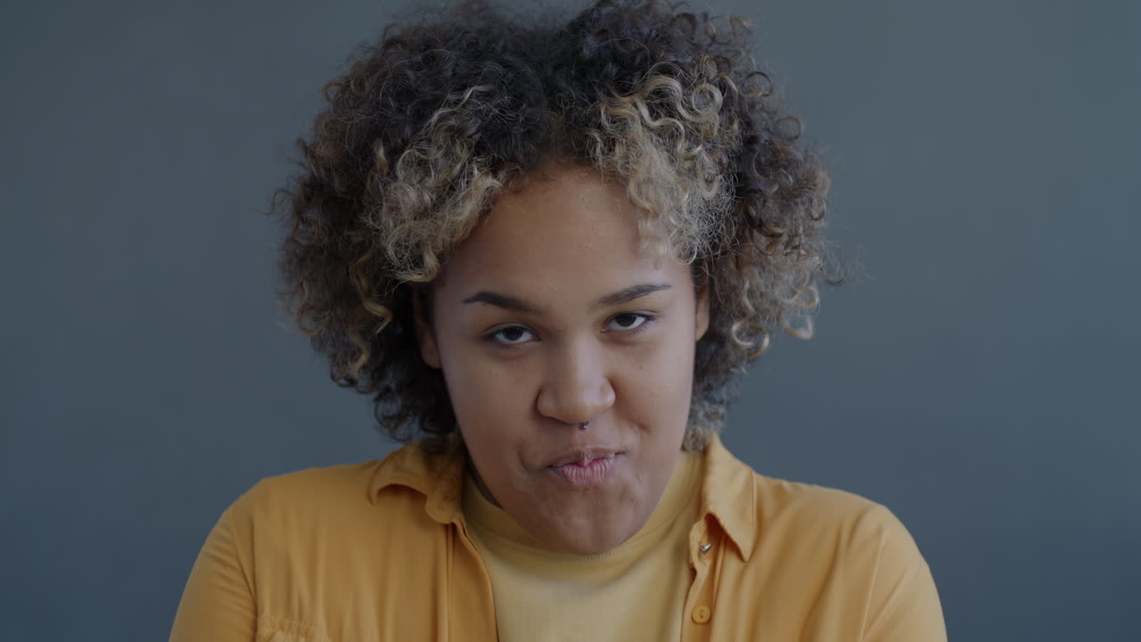 Woman with Curly Hair in Yellow Shirt