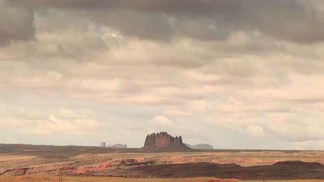 Longshot-Of-A-Sandstone-Formation-And-Surrounding-Landscape-At-Monument-Valley-Tribal-Park-In-Arizona-And-Utah