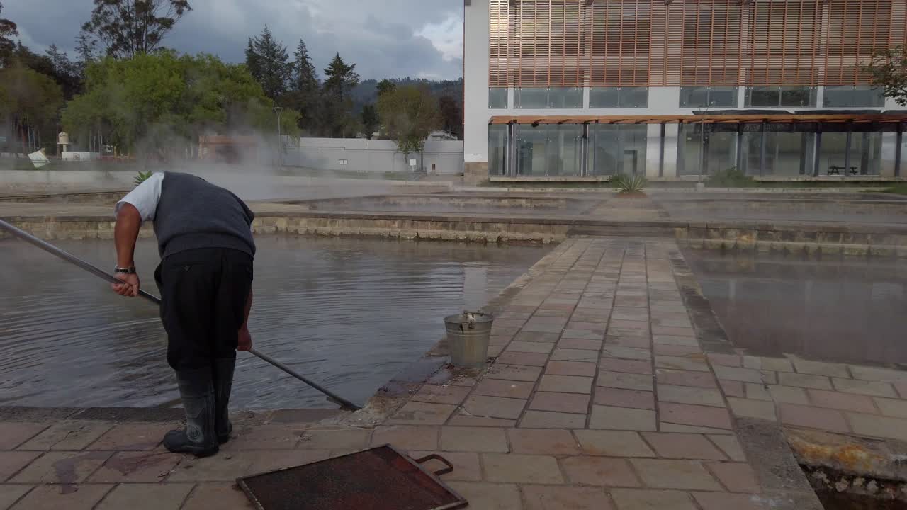 Thermal Spa Maintenance Staff Skimming Pool At Banos Del Inca, Peru
