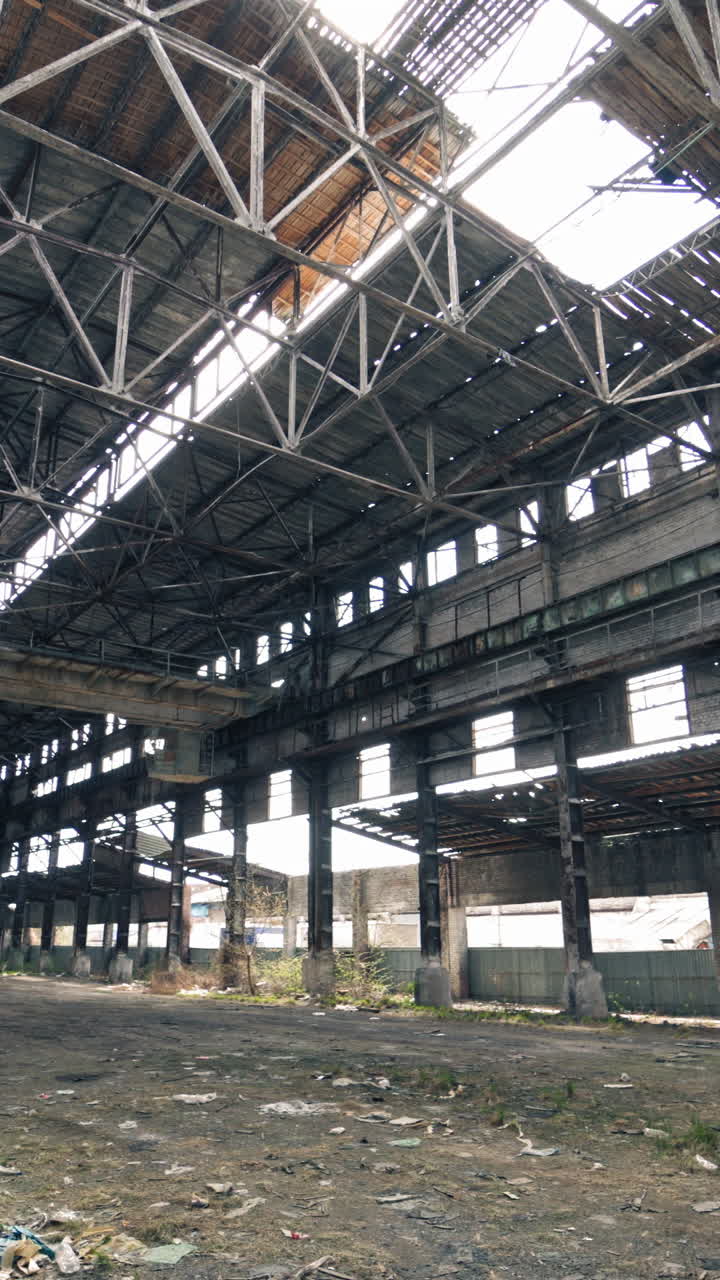 Large abandoned industrial hall. Territory of abandoned industrial area waiting for demolition Vertical video