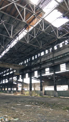 large abandoned industrial hall. territory of abandoned industrial area waiting for demolition vertical video