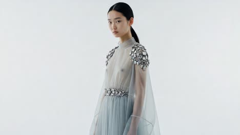 Elegant fashion showcase featuring a model in a stunning translucent gown, highlighting intricate embellishments and flowing design from various angles