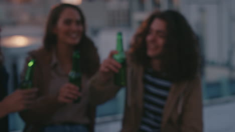 young-man-using-polaroid-camera-photographing-weekend-party-celebration-at-sunset-happy-friends-hanging-out-on-rooftop-posing-for-photo-making-toast