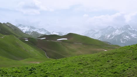 Green-hills-with-rests-of-snow-in-the-Alps-near-the-Mont-Blanc