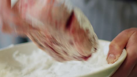 Woman-rolling-veal-shank-in-flour-before-frying