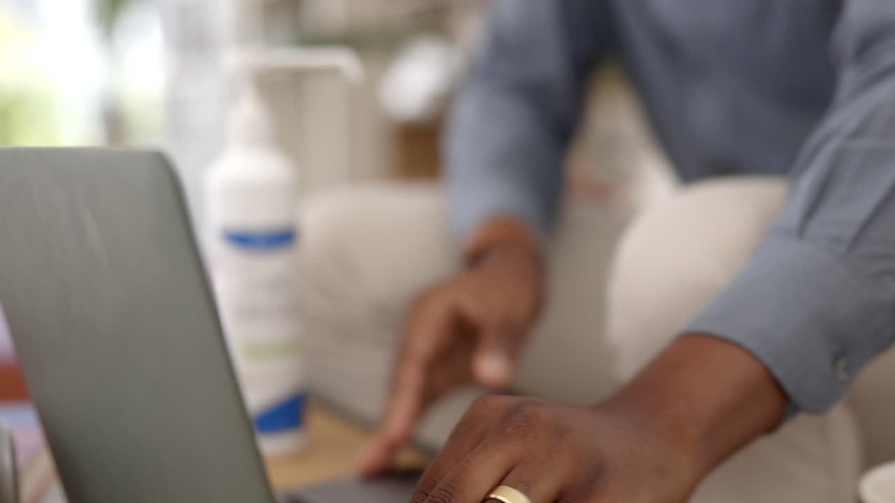 Sanitizer, laptop and person hands cleaning