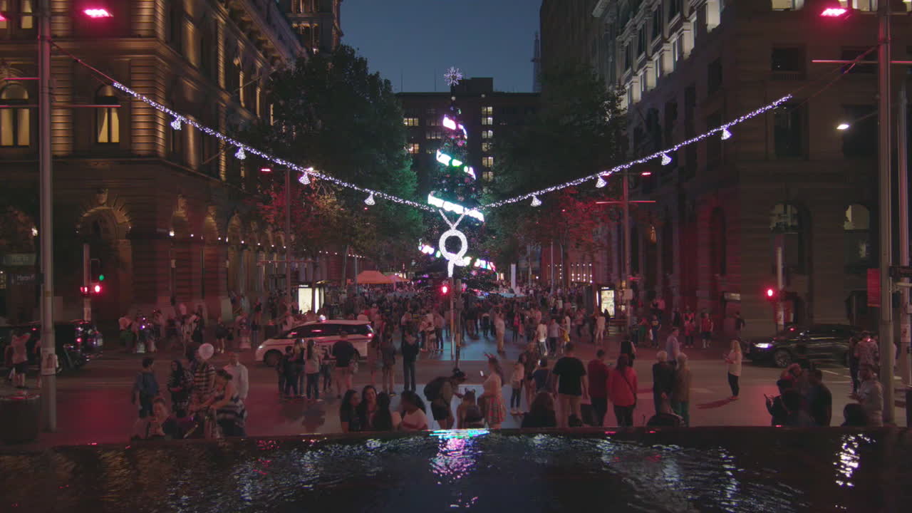 Amazing large christmas tree with crowd surrounding and water fountain at Martin place in Sydney Australia