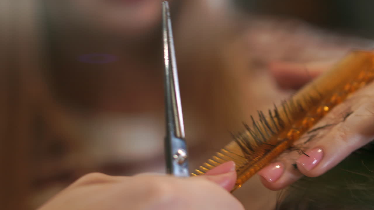 Hairdresser cutting hair with professional scissors and comb in hairdressing salon. Close up haircutter making male haircut with scissors in hairdressing school