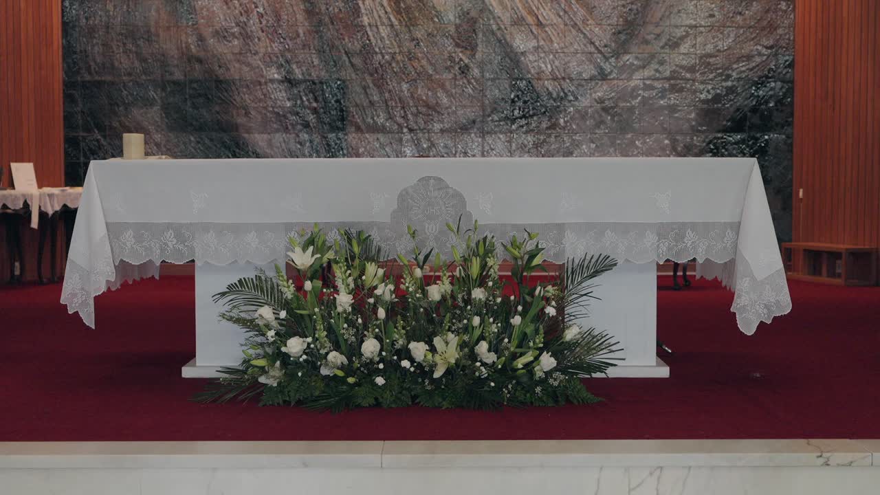 white altar with delicate flowers and lace in solemn sacred setting