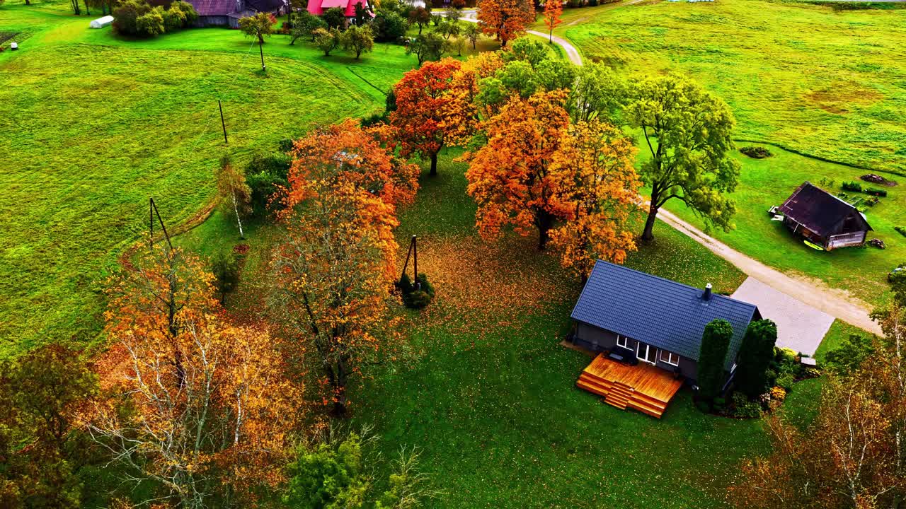 Aerial view of country house and autumn trees in tranquil rural setting