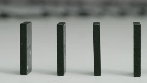 row of black dominoes in studio