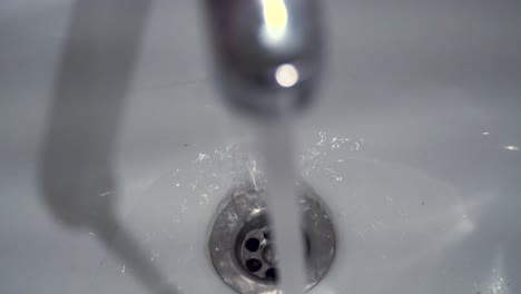 water running into a sink drain