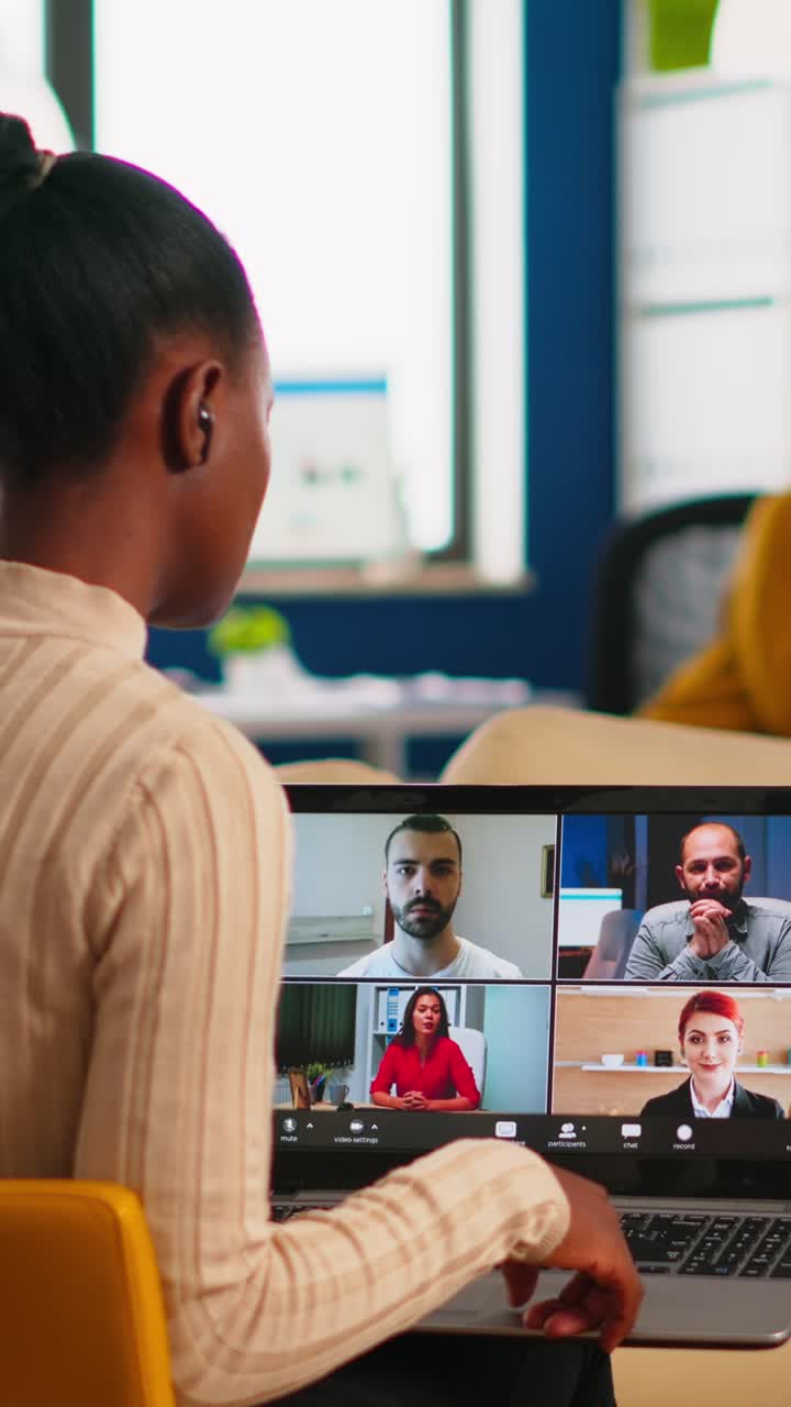 Vertical video African manager woman discussing with remote colleagues using video call