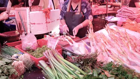 butcher cutting and arranging meat for sale