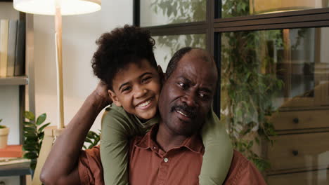 black man and boy in the living room