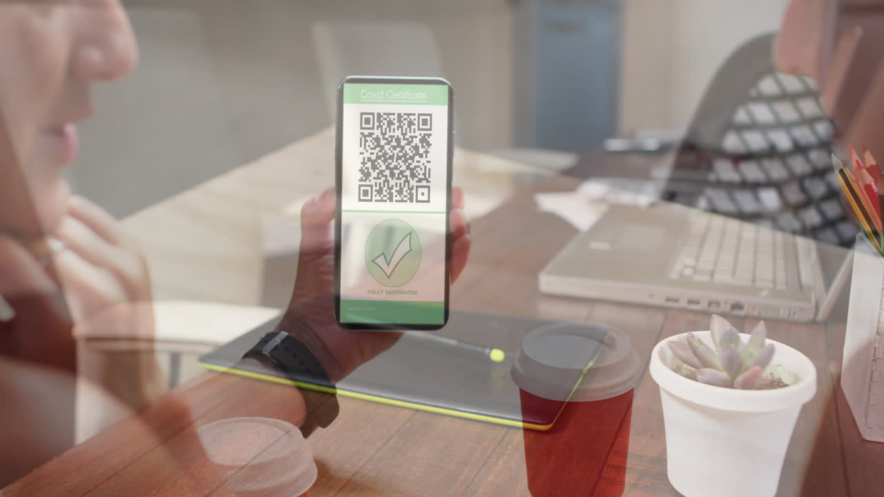 Animation of woman holding smartphone with covid 19 vaccination passport over office