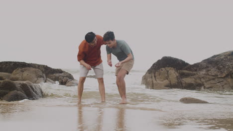 couple picking shells at the shore