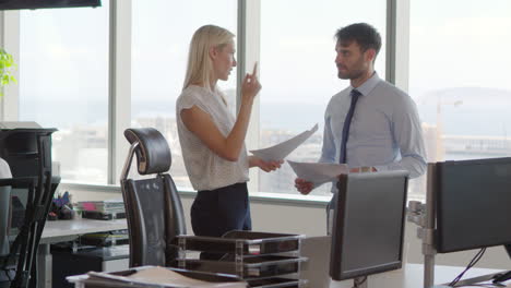 businesspeople working at office desk on computer together