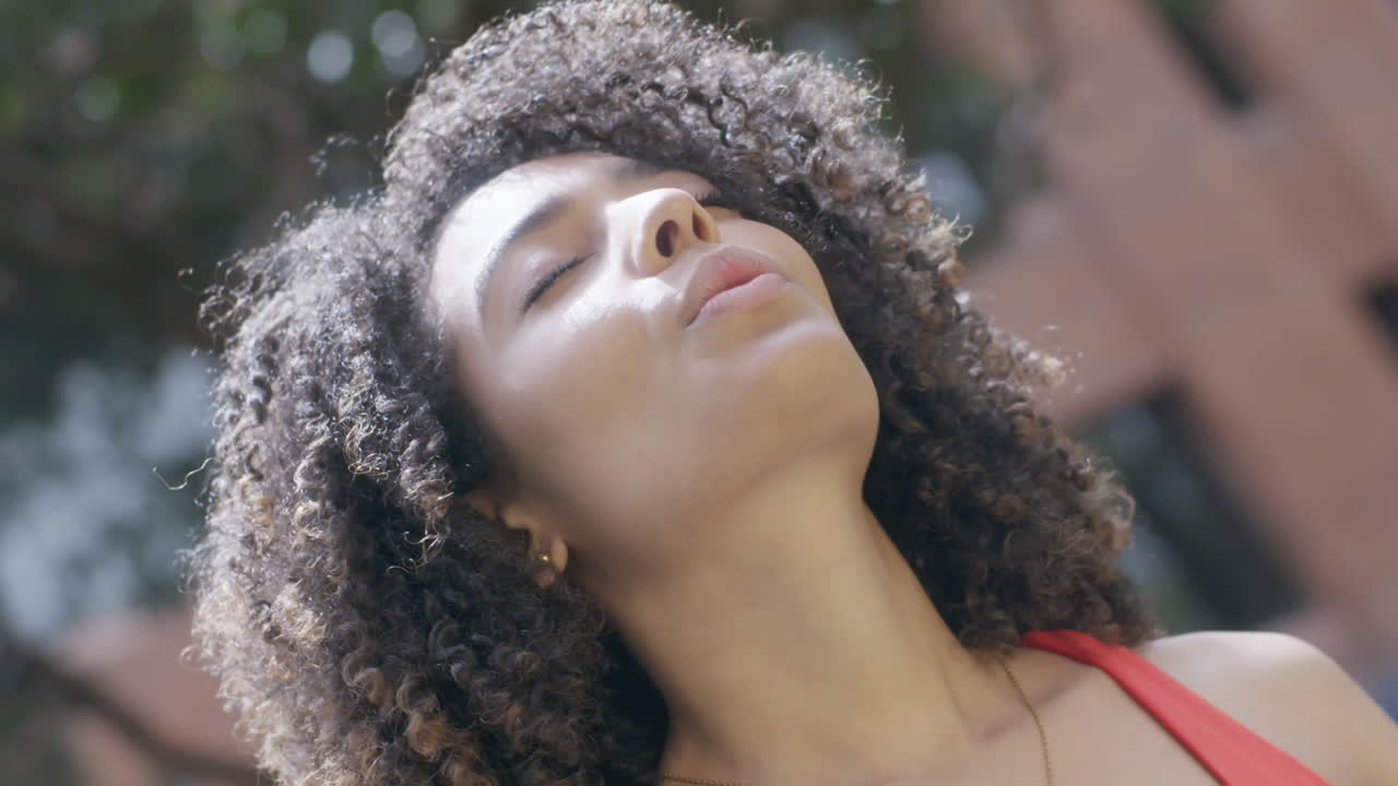 Close-up view of the pretty model's face basks in the sun, radiating a sense of harmony and tranquility that inspires those around her