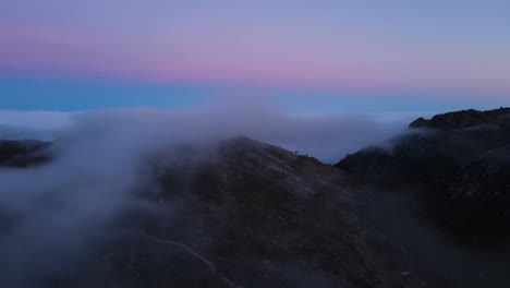 aerial view of a beautiful foggy mountain valley after sunset