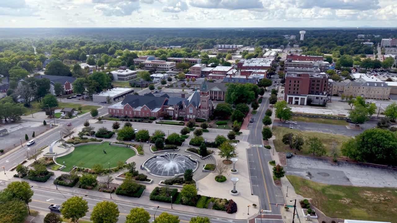 Aerial View of a Cityscape with Buildings, Park, and Fountain