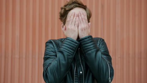 man with a confused expression in a leather jacket