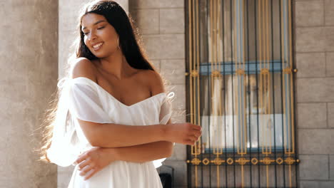 smiling woman in white dress outdoors