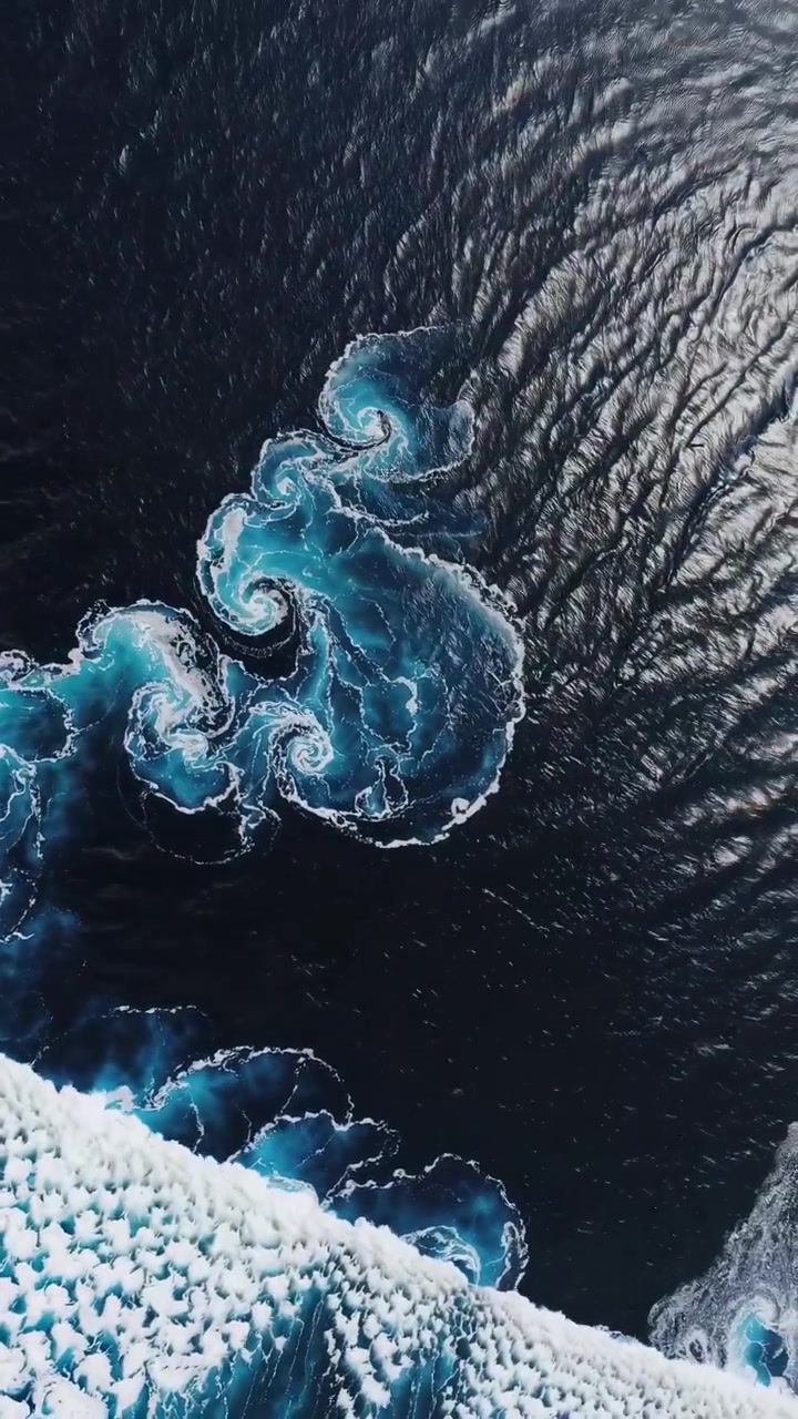 Aerial View of Ocean Waves and Swirling Currents