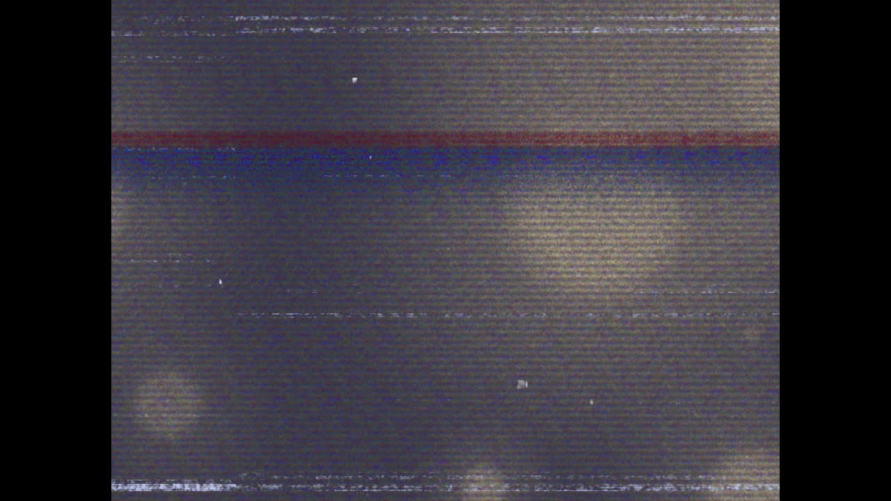 Animation of glitch interference over glowing spots on black background