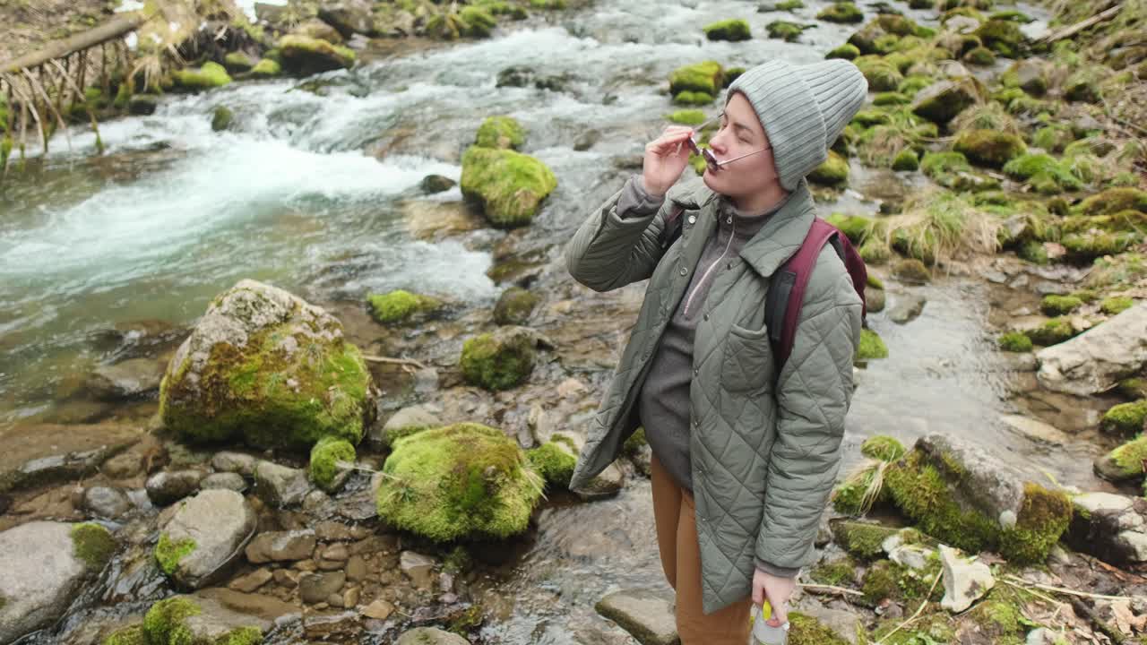 Woman hiking in a mountain stream