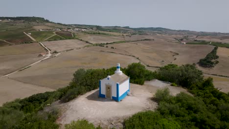 aerial 180º close shot of ancient chapel of nossa senhora do monte in arruda dos vinhos in portugal