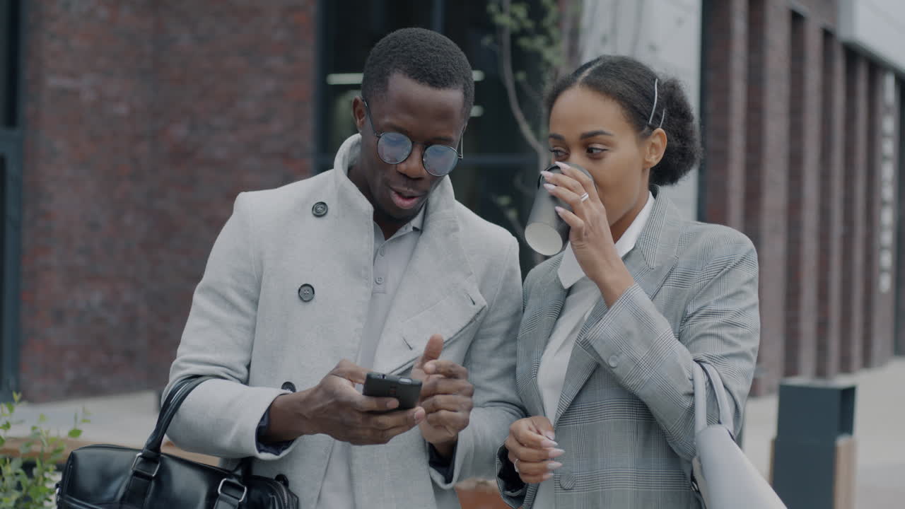Business Colleagues Discussing on Smartphone