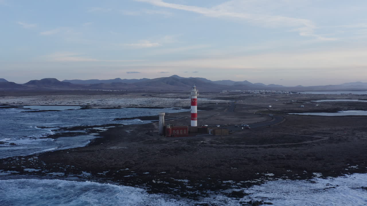 Aerial View of a Lighthouse on a Volcanic Island at Sunset