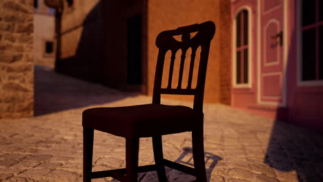 an old wooden chair sits on a cobblestone street in an old town