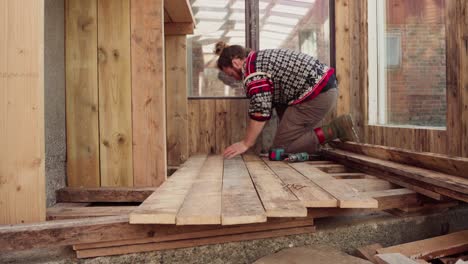 installing wooden floor inside the greenhouse in the farm